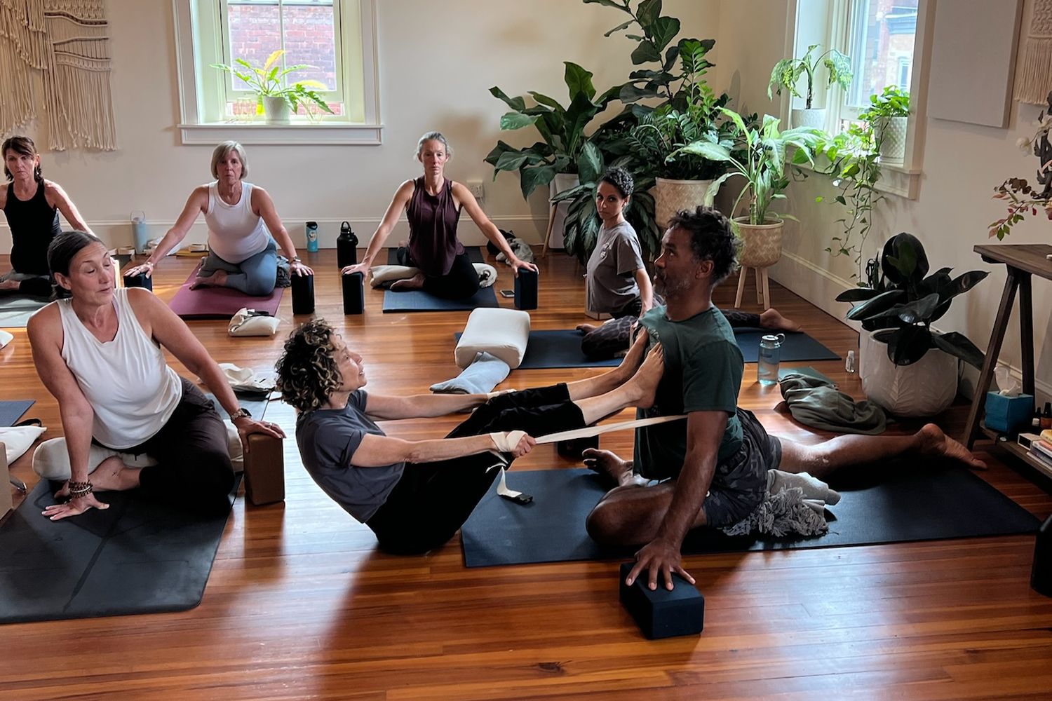 a room of students practicing on the wood floor of the studio